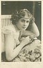 Image 5 - CASSIVE woman with pearls around head, leans forward, right hand on cushion