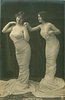 Image 1 - both stand facing left, girl on left looks front, one hand of girl on right on shoulder of girl in front, girl on right looks straight right