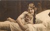 Image 1 - mother in bed with child, back, her right hand on front bed, child lies prone with legs back