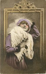 pretty girl with ermine fur & cap posed in front of framed mirror, she faces front looks up, her left hand on head, her right hand on fur in front of her