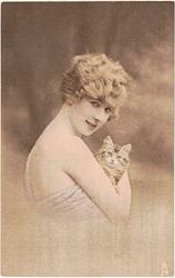 girl faces right looking front holds kitten in right arm, left hand not visible