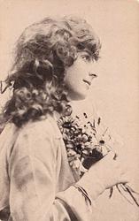 girl right profile, holds flowers to chest, looks & faces right