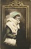 Image 2 - pretty girl with ermine fur & cap posed in front of framed mirror, she faces right looks partly right & up