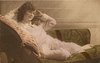 Image 2 - girl lying left on couch, both hands at sides of her head, right elbow rests on pillow