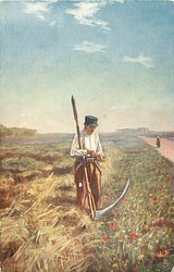 man stands at edge of corn fields, scythe in front, road far right