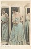 Image 1 - LIANE DE VRIES standing looks at reflection in three mirrors, hands together at waist