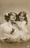Image 1 - girl touches mothers chin