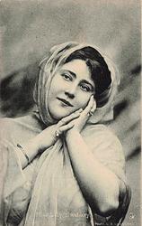 MISS LILY HANBURY hands both at her face, facing front, looking left/up,shawl over hair