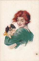 Woman in green dress holding dog,