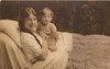Image 1 - mother in bed with child, mother left, her left hand around child's left arm, her right hand is by child's right chest