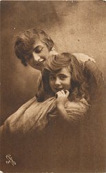 mother & daughter, head & shoulders, mother behind with eyes closed, daughter looks front hand to face