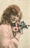 Image 2 - girl right profile, holds flowers to left cheek, looks at camera