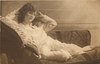 Image 1 - girl lying left on couch, both hands at sides of her head, right elbow rests on pillow