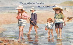 ON THE SANDS four children paddle
