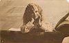Image 1 - girl lying on couch,looking front, both hands under her chin