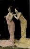 Image 1 - both stand facing left, looking left & up, both hands of girl on right on shoulder of girl in front