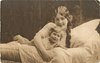 Image 1 - mother in bed with child, back, her right hand on front bed, child lies prone with legs back