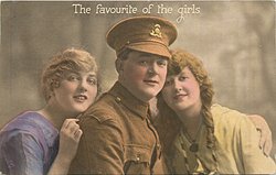 soldier between two girls, hat on soldier, all three face forward, left girl has hand on soldier's shoulder