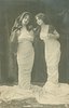 Image 1 - girl on right has arm behind other girl & leans toward her, both look down