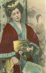 young woman in Japanese dress faces front looking down, holding fan & roses