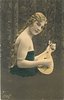 Image 1 - pretty girl with long hair in off shoulder dress faces right with mandolin held before her, looks front, braid down her back