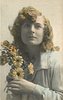 Image 2 - girl left profile, holds flowers to her right cheek, looks upward towards camera