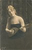 Image 1 - pretty girl with long hair in off shoulder dress faces partly left with mandolin held in before her, looks up & right