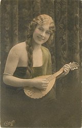 pretty girl with long hair in off shoulder dress faces partly right with mandolin held in before her, looks front, braid over her right shoulder