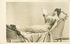 Image 1 - woman in low cut dress sits reading, with legs up on another chair