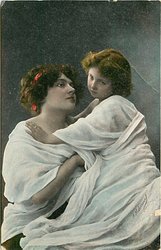 mother and child, child has her hands on mother's shoulders, mother has her right hand tucked under daughter
