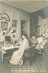 MME.REJANE DANS SA LOGE seated in front of mirror appling make-up