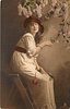Image 1 - girl sits on stepladder facing right, looking front, touching lilac in front of her with her right hand & holding single rose on her lap with her left