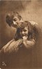 Image 1 - mother & daughter, head & shoulders, mother behind with eyes closed, daughter looks front hand to face