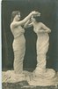 Image 1 - they face each other, girl on left adjusts flowers on the head of her partner