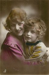 woman left, child right, woman right hand behind child, child left hand at woman's shoulder