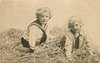 Image 1 - two boys play in straw, both on hands & knees, looking forward
