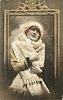 Image 1 - pretty girl with ermine fur & cap posed in front of framed mirror, she faces front looks up, both hands hold fur in front of her
