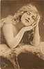 Image 1 - pretty girl poses, both elbows on fur, both hands to left side of face