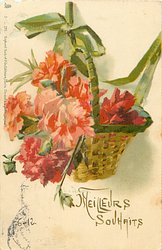 basket of red & orange carnations hanging from green ribbon