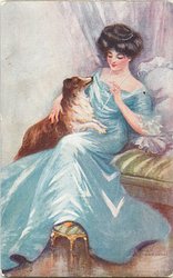collie on lap of pretty lady looks up at her face