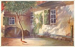 building with green window shutters, chicken under blossom tree in foreground