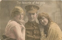 soldier between two girls, hat on soldier, all three face forward, both girls have both hands on soldier's shoulders