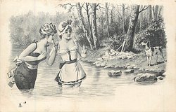 dog on bank looks at two girls in water, trees behind