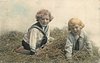 Image 1 - two boys play in straw, both on hands & knees, looking forward