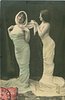 Image 1 - both stand facing left, girl on left twists to look front,both hands at her shoulder, girl on right adjusts shawl of girl in front, looking at the shawl
