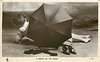 Image 1 - A PEBBLE ON THE BEACH young woman lies on beach behind umbrella