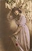 Image 1 - girl facing left leaning on step-ladder, looking front, holding rose with left hand, lilac above