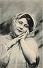 Image 1 - MISS LILY HANBURY hands both at her face, facing front, looking left/up,shawl over hair