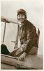 Image 1 - seated on back edge of cockpit, smiling