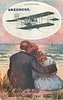 Image 3 - inset CODY IN FULL FLIGHT couple cuddle on sands facing out to sea, she wears a blue dress
